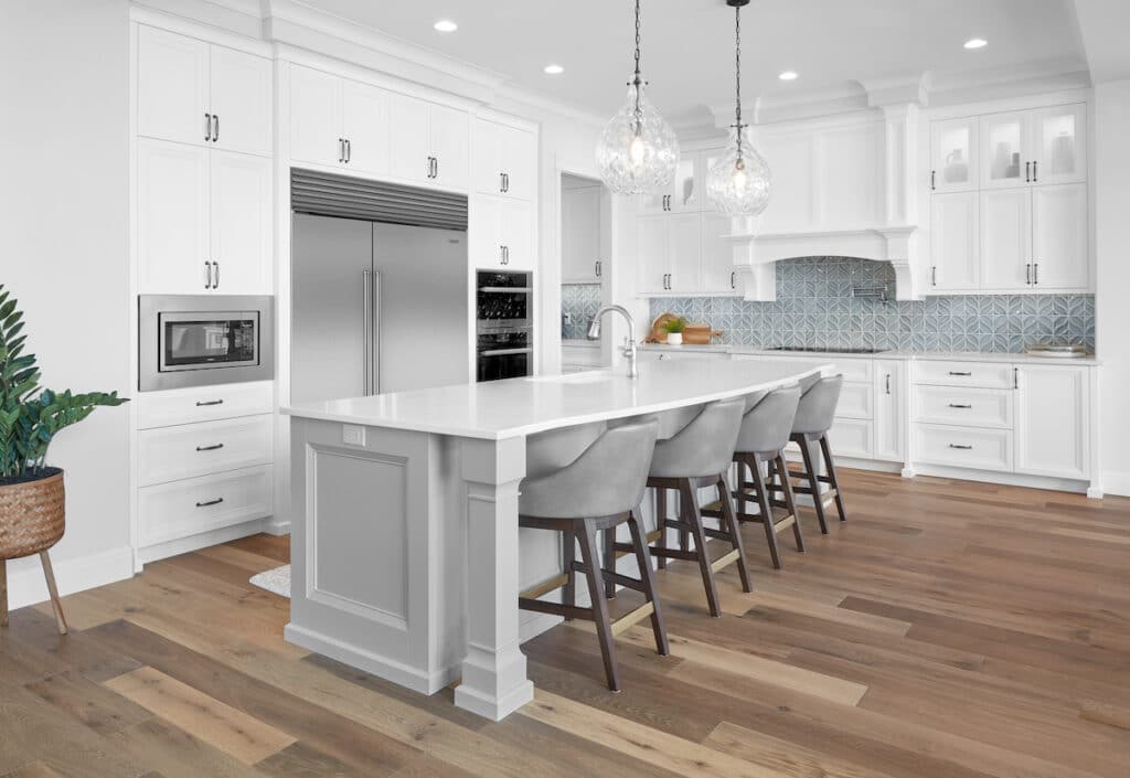 modern kitchen, white lacquer cabinets, quartz countertops, gray island, stacked crown, slim shaker style doors